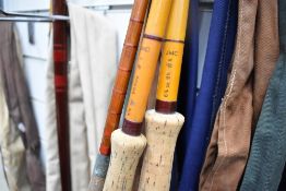 Three vintage fly fishing rods with sleeves