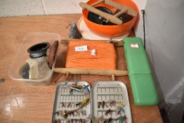 An assortment of fishing tackle including flies, lures and reel.