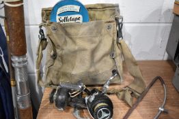 A fishing tackle bag and contents including two reels.