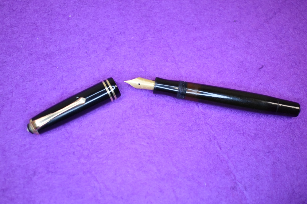 A Montblanc 245 EF piston fill fountain pen in black with gold trim, having a Montblanc 6 nib.