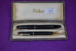 A Parker Duofold button fill fountain pen and propelling pencil set in black with narrow decorated