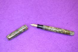 A Parker Premiere fountain pen in green marble with red fleck, single narrow band to cap, with