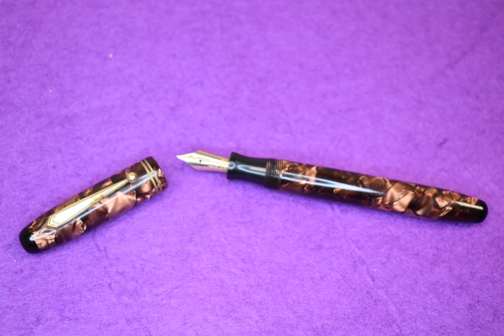 A Parker Parkette leverfill fountain pen in pink marble with two narrow bands to cap. With Parker