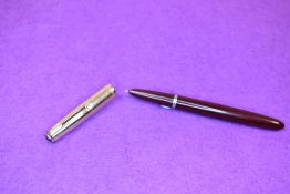 A Parker 51 fountain pen in burgundy with 12k gold filled cap. Approx 13.6cm. Minor dint in cap