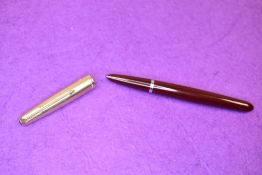 A Parker 51 fountain pen in red with a rolled gold cap. Approx 14.2cm