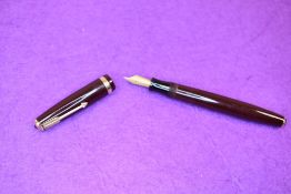 A Parker Duofold NS button fill fountain pen in chocolate brown with a broad part decorated band