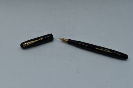 A Mabie Todd & Co Swan 3160 Self filler leverfill in black having a single narrow gold band to cap
