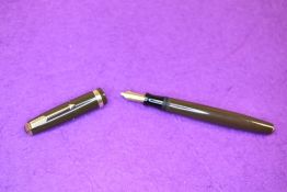 A Parker Duofold button fill fountain pen in brown with decorated broad band to cap, having a Parker