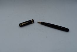 A Mabie Todd & Co Swan Self filler leverfill in black having a single gold band to cap with Swan No2