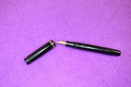 A Parker Duofold in black. With two narrow rings to cap, button fill, Parker Duofold nib. Approx