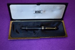 A Montblanc No149 piston fill fountain pen in black with gold trim having a MB4810 nib, in