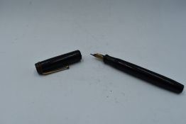 A Parker Duofold in black, button fill, with bands missing from cap and slight scratching to barrel