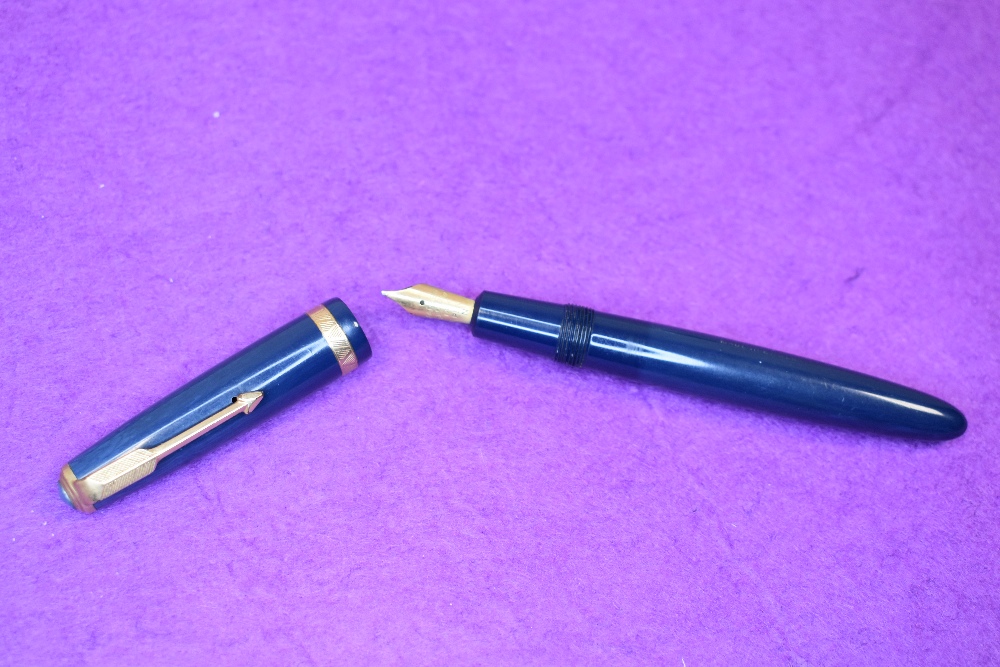 A Parker Duofold fountain pen in blue, (made in England) with a decorated broad band to the cap.