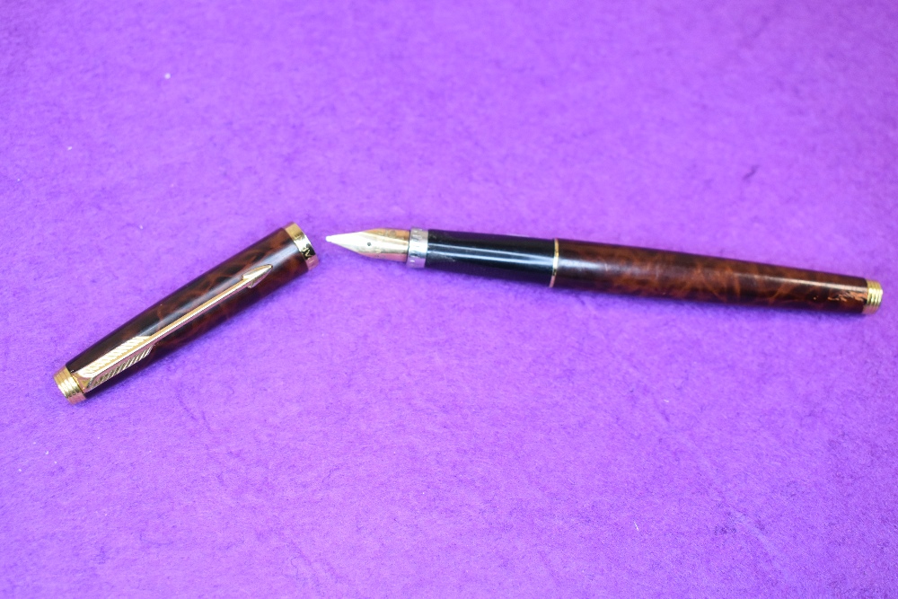 A Parker Premier Fountain pen in laque with a single band to rim of the cap, having a Parker made in