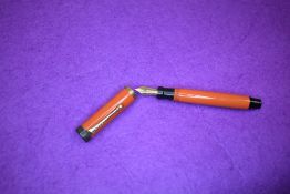 A Parker Duofold Jnr Lucky Curve button fill fountain pen in orange with single broad band to cap