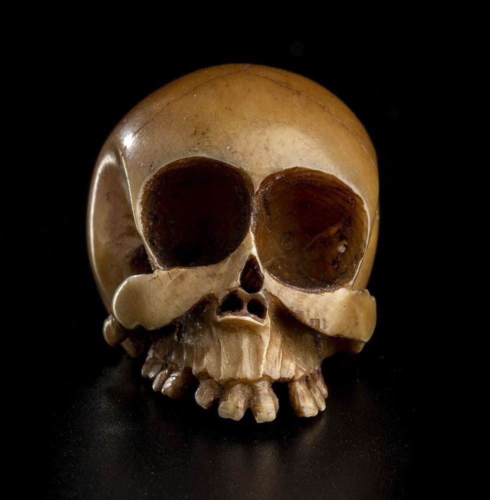 AN IVORY OKIMONO WITH A SKULLJapan, Meiji period