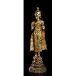 A GILT METAL STANDING BUDDHA Thailand, 20th century
