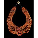 A BREAST NECKLACE WITH ORANGE BEADS