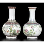 A PAIR OF PORCELAIN BOTTLE VASES WITH POLYCHROME DECORATIONChina, first half of the 20th century