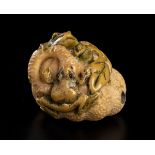 AN IVORY NETSUKE WITH FRUIT AND FROGSJapan, 20th century