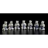 SEVEN GLAZED PORCELAIN SEATED CHILDREN China, Qing dynasty, 1750 circa