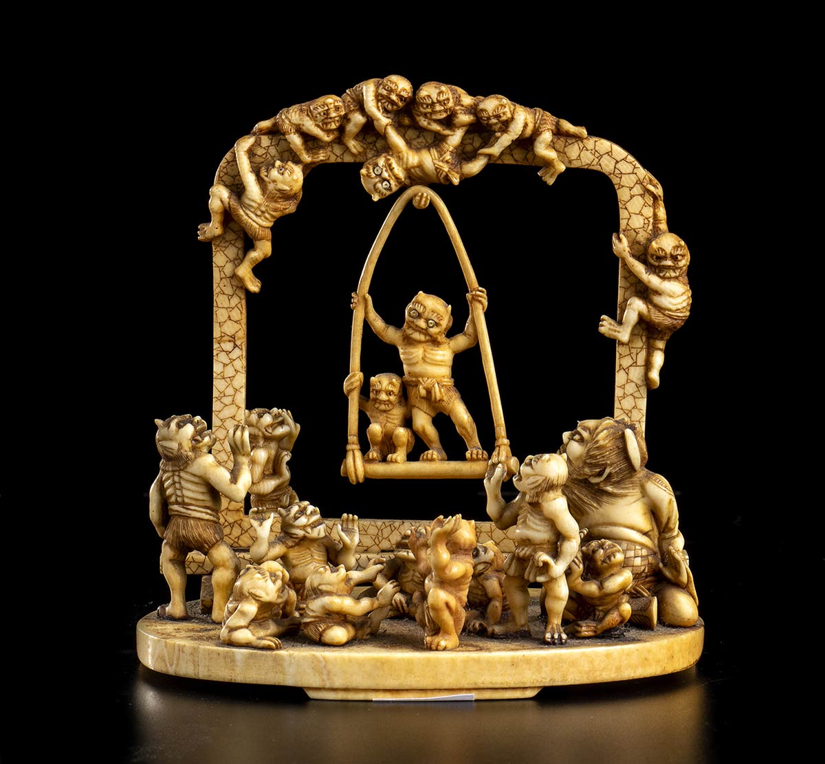 AN IVORY OKIMONO WITH ONI ON A SWINGJapan, Meiji period