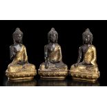 THREE PARTIALLY GILT METAL BUDDHA China, 20th century