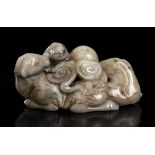 A CREAM AND DARK BROWN JADE GROUP WITH THREE RAMS AND LINGZHI FUNGUSES China, 17th century