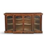 A VICTORIAN GONCALO ALVES FOUR DOOR BREAKFRONT BOOKCASE, with plain figured top above glazed panel