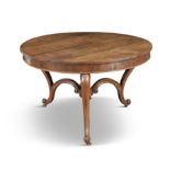 A ROSEWOOD LIBRARY TABLE, mid-19th century, of circular form, on three scroll cabriole legs joined