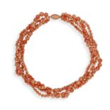 A CORAL BEAD NECKLACE, composed of four rows of angel's skin coral beads highlighted with reeded