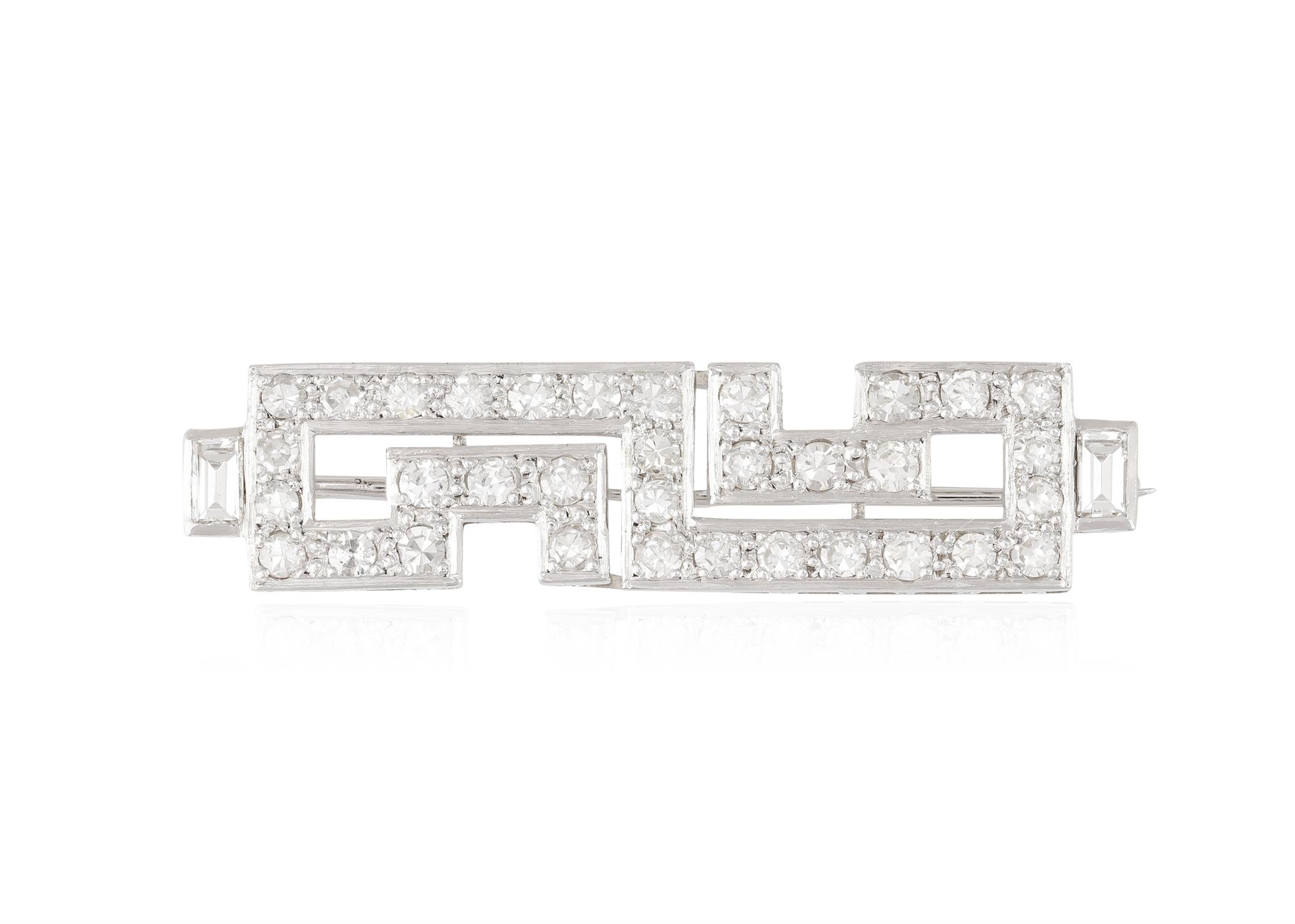 A DIAMOND BROOCH, of geometric design set with single-cut diamonds throughout with two baguette-