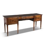 A 19TH CENTURY INLAID MAHOGANY BOWFRONT SIDEBOARD IN THE SHERATON TASTE, the shaped rectangular