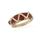 A GARNET RING, composed of fancy-cut garnets, mounted in 9K gold, ring size L