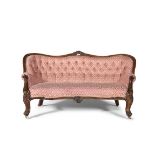 A VICTORIAN LOUIS QUINZE WALNUT UPHOLSTERED COUCH, the moulded frame surmounted with foliage above a