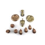 A COLLECTION OF COPPER AND BRASS WARE, comprising seven miniature copper jelly moulds, varying