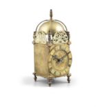 A 19TH CENTURY BRASS LANTERN CLOCK, of squared shape with domed top, strapwork turned finial, over