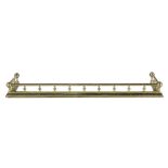 A CAST BRASS CURB FENDER, the plain rail top supported on reeded turned supports and with reeded