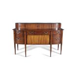 AN UNUSUAL GEORGE III MAHOGANY AND SATINWOOD BANDED SIDEBOARD, of bowed design, with raised