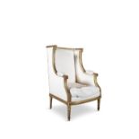 A FRENCH GILTWOOD FAUTEUIL A L'OREILLES, late 19th century, in the Louis XVI style, with curved
