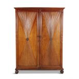 A FRENCH LATE 19TH CENTURY CHERRYWOOD ARMOIRE, the twin cupboard doors decorated with fluted hour