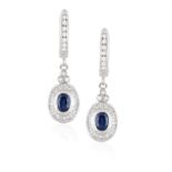 A PAIR OF SAPPHIRE AND DIAMOND PENDENT EARRINGS, each oval-shaped sapphire set within a surround