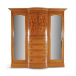 AN EDWARDIAN INLAID SATINWOOD BOWFRONT WARDROBE, a moulded dentil cornice above twin half cupboards,