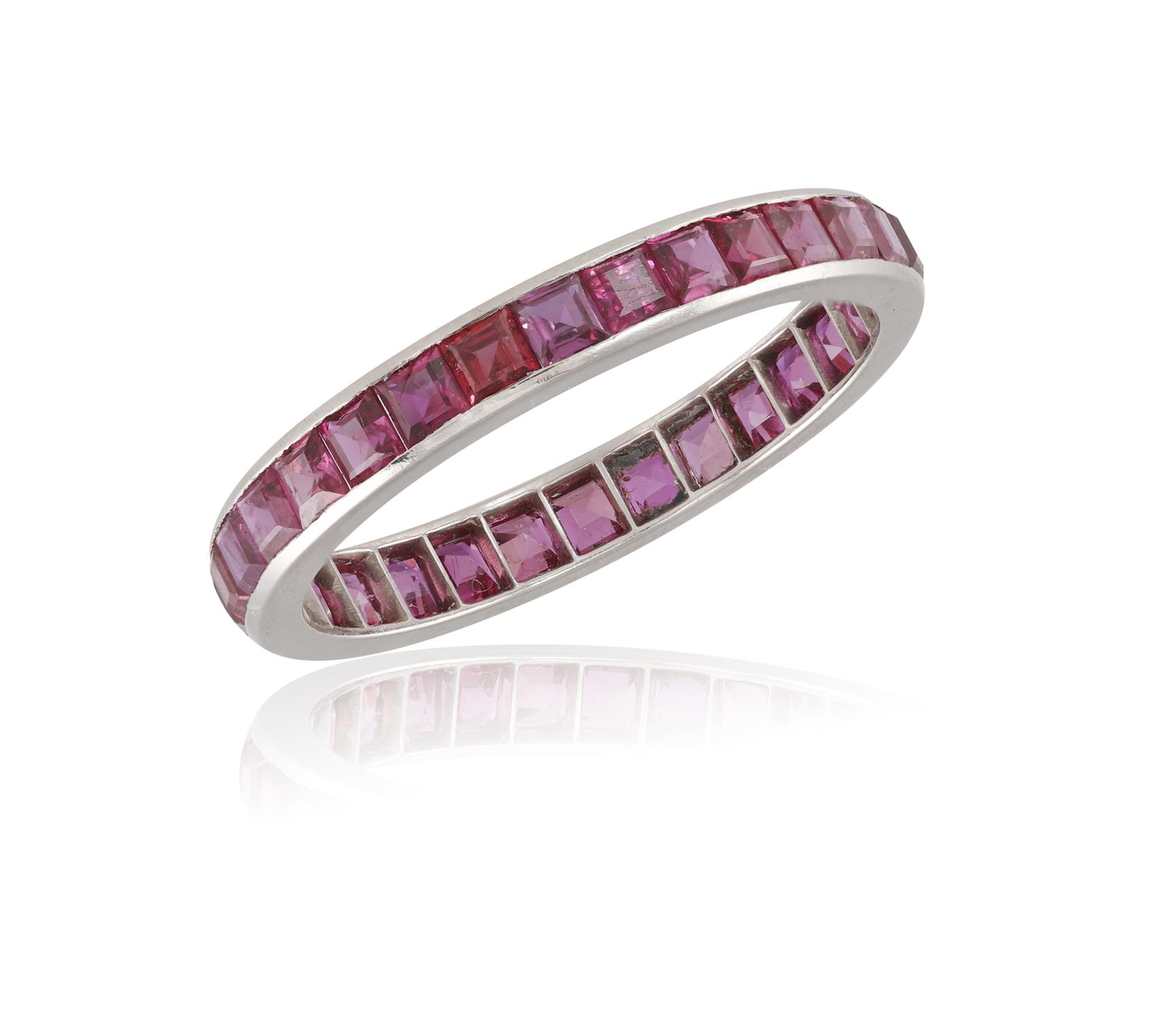 A RUBY ETERNITY RING, composed of a single row of channel-set calibré-cut rubies, ring size V¾