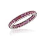 A RUBY ETERNITY RING, composed of a single row of channel-set calibré-cut rubies, ring size V¾