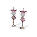 A PAIR OF WALKER AND HALL SILVER PLATED AND CRANBERRY GLASS OIL LAMPS, with frosted glass shaded and