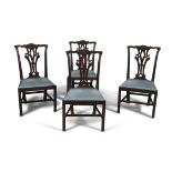 A SET OF FOUR GEORGE III MAHOGANY DINING CHAIRS, each with pierced splat back, fitted drop in