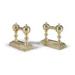 A PAIR OF VICTORIAN BRASS FIRE DOGS, with twin reeded ball and rail supports, on rectangular