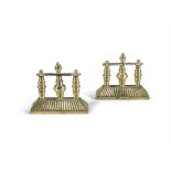 A PAIR OF BRASS FIRE DOGS, with three column supports on rectangular reeded tapering base. 19cm