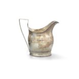 AN IRISH PROVINCIAL SILVER HELMET SHAPED CREAM JUG, Cork c. 1790, mark of James Warner and struck '